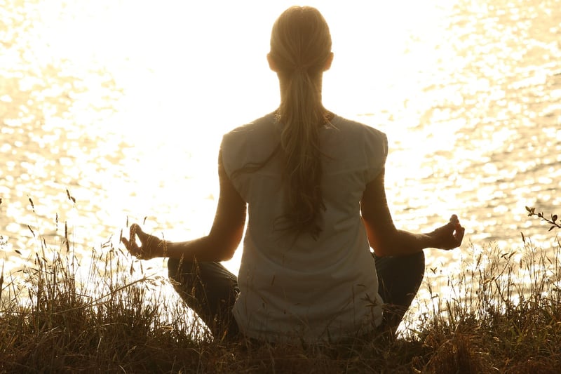 Woman meditating and practicing deep belly breathing